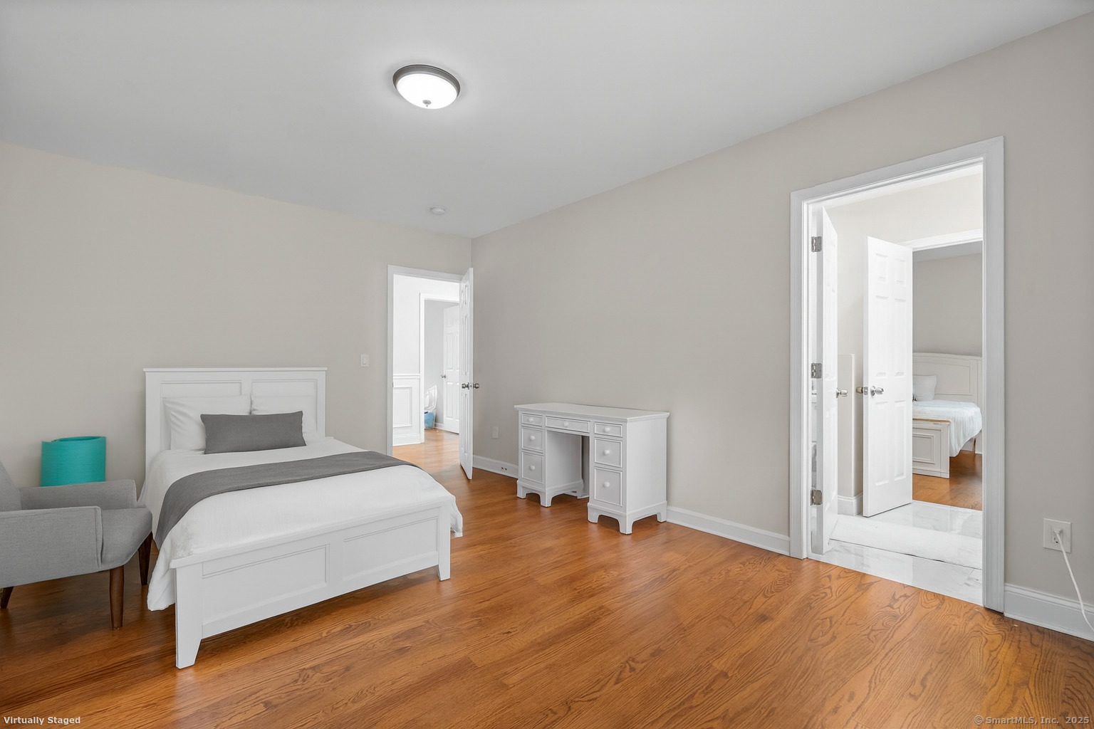 424 Racebrook Road Orange, CT 06477 - Photo 19 of 36 a bedroom with a bed and a potted plant