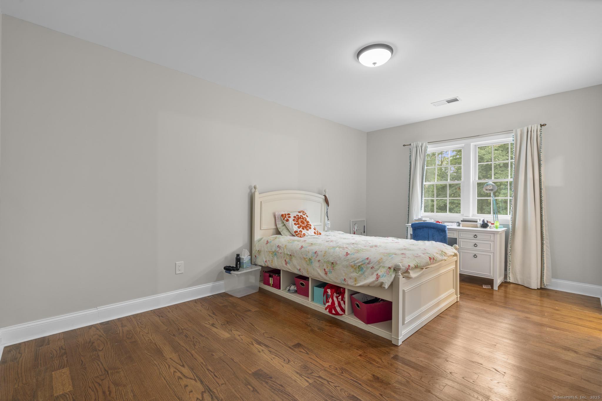 424 Racebrook Road Orange, CT 06477 - Photo 21 of 36 a bed room with a bed and a window