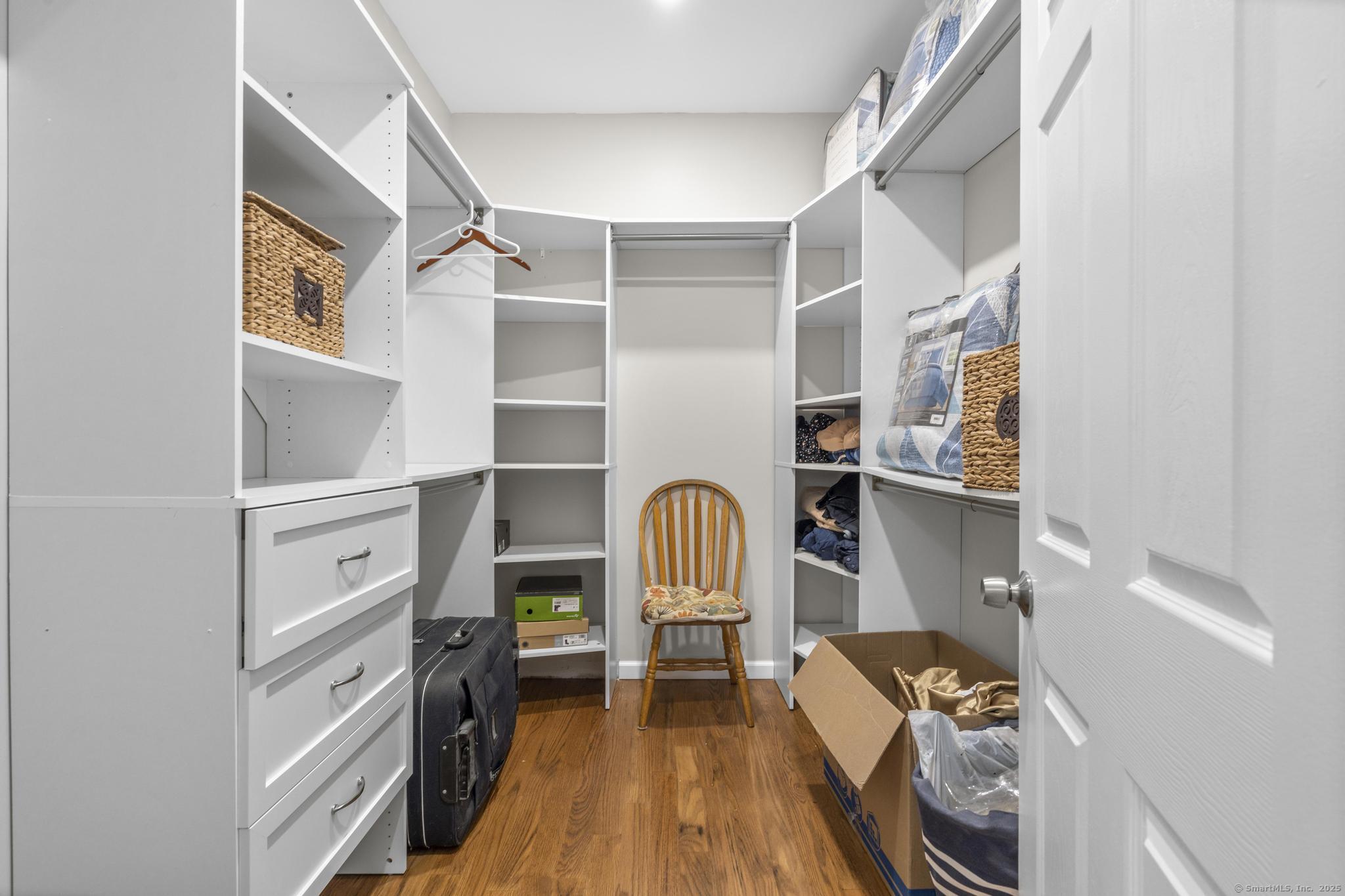 424 Racebrook Road Orange, CT 06477 - Photo 28 of 36 a view of walk in closet with clothes and shoes