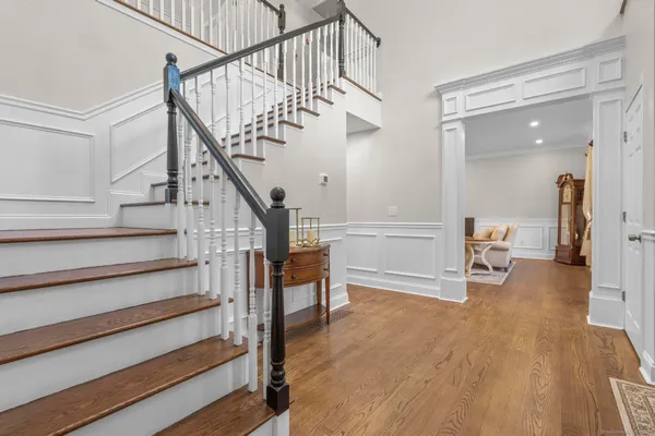 a view of hallway with wooden floor and stairs