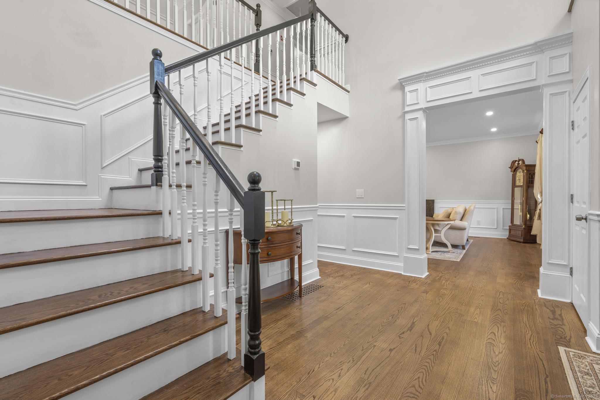 424 Racebrook Road Orange, CT 06477 - Photo 5 of 36 a view of hallway with wooden floor and stairs
