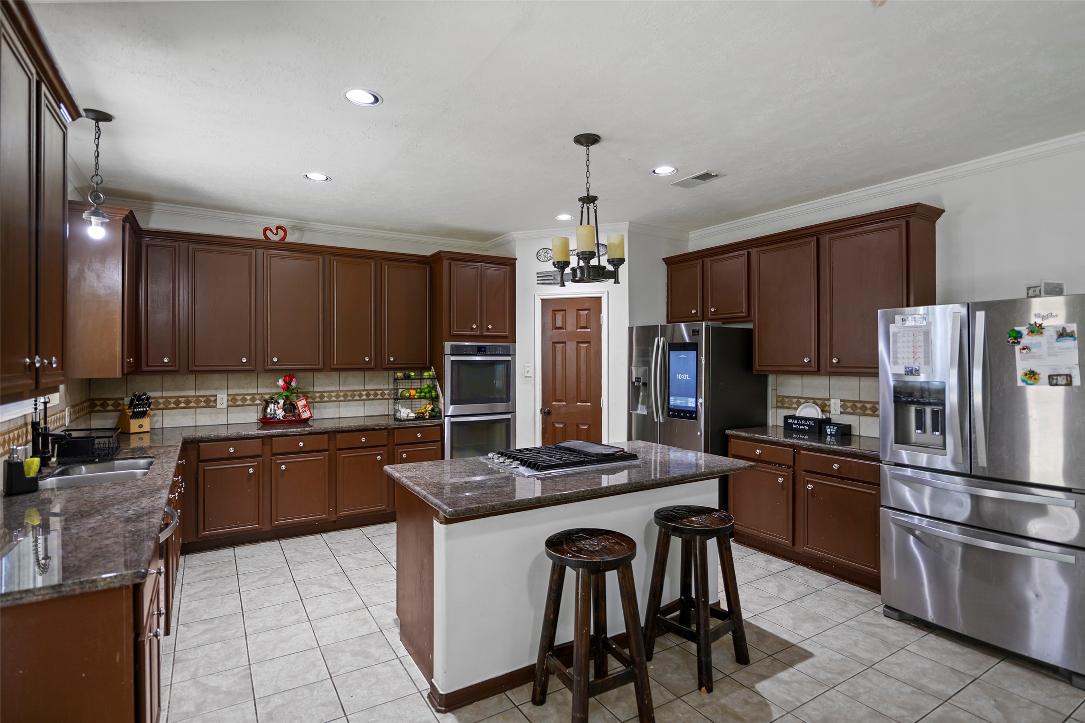 9211 Memorial Grove Drive Spring, TX 77379 - Photo 8 of 47 Island kitchen with gas cooktop.