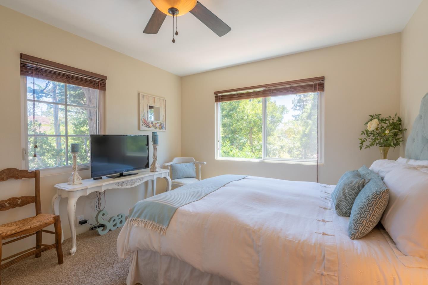 25324 Hatton Road Carmel, CA 93923 - Photo 13 of 19 a bedroom with a bed window and a flat screen tv