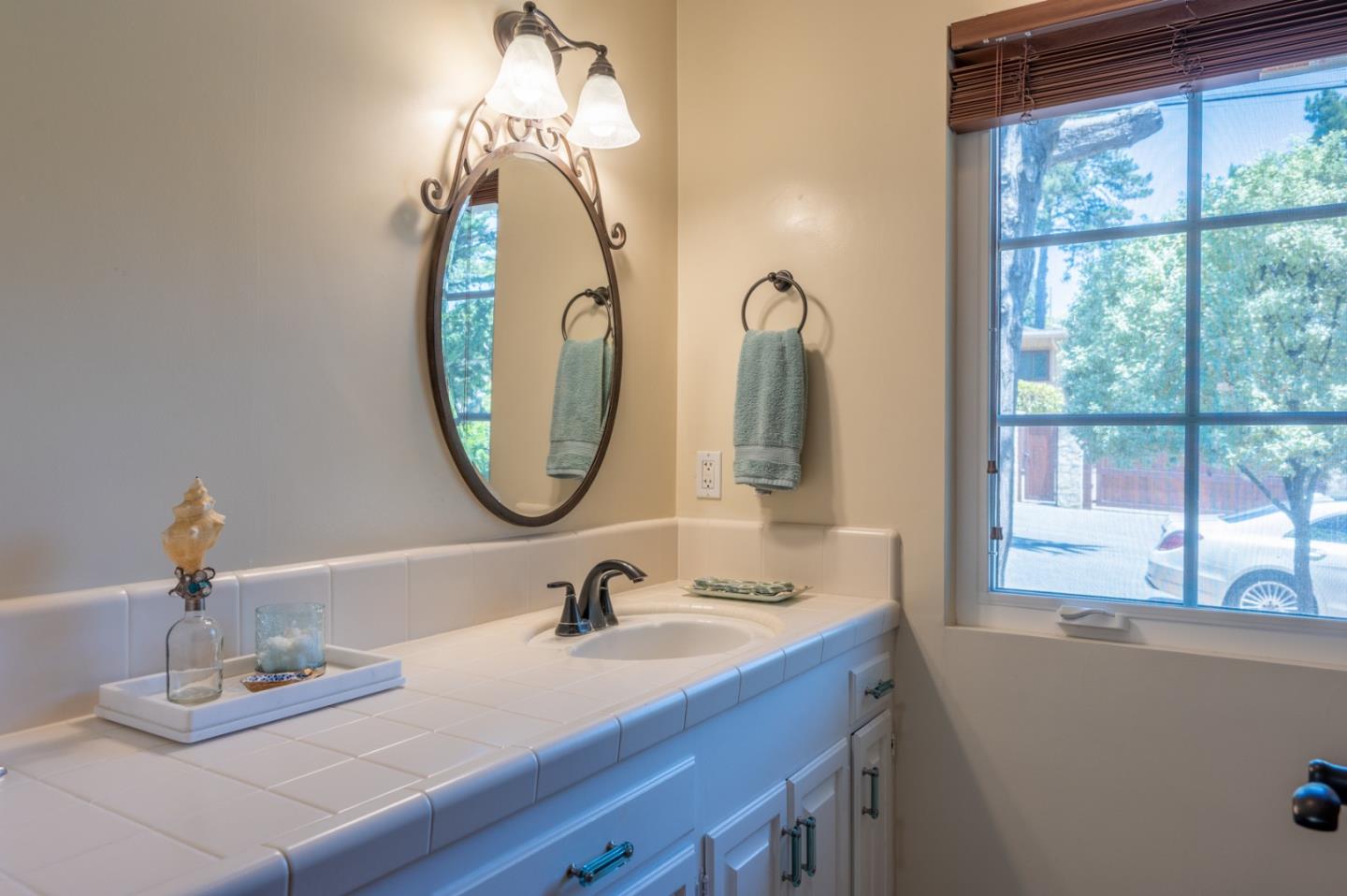 25324 Hatton Road Carmel, CA 93923 - Photo 15 of 19 a bathroom with a sink and a mirror