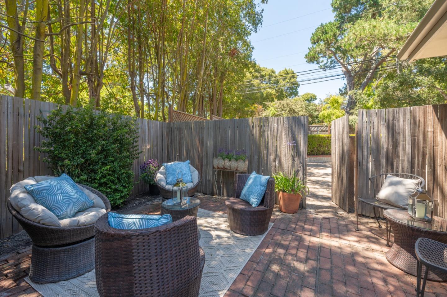 25324 Hatton Road Carmel, CA 93923 - Photo 16 of 19 a view of a patio with table and chairs potted plants and a large tree