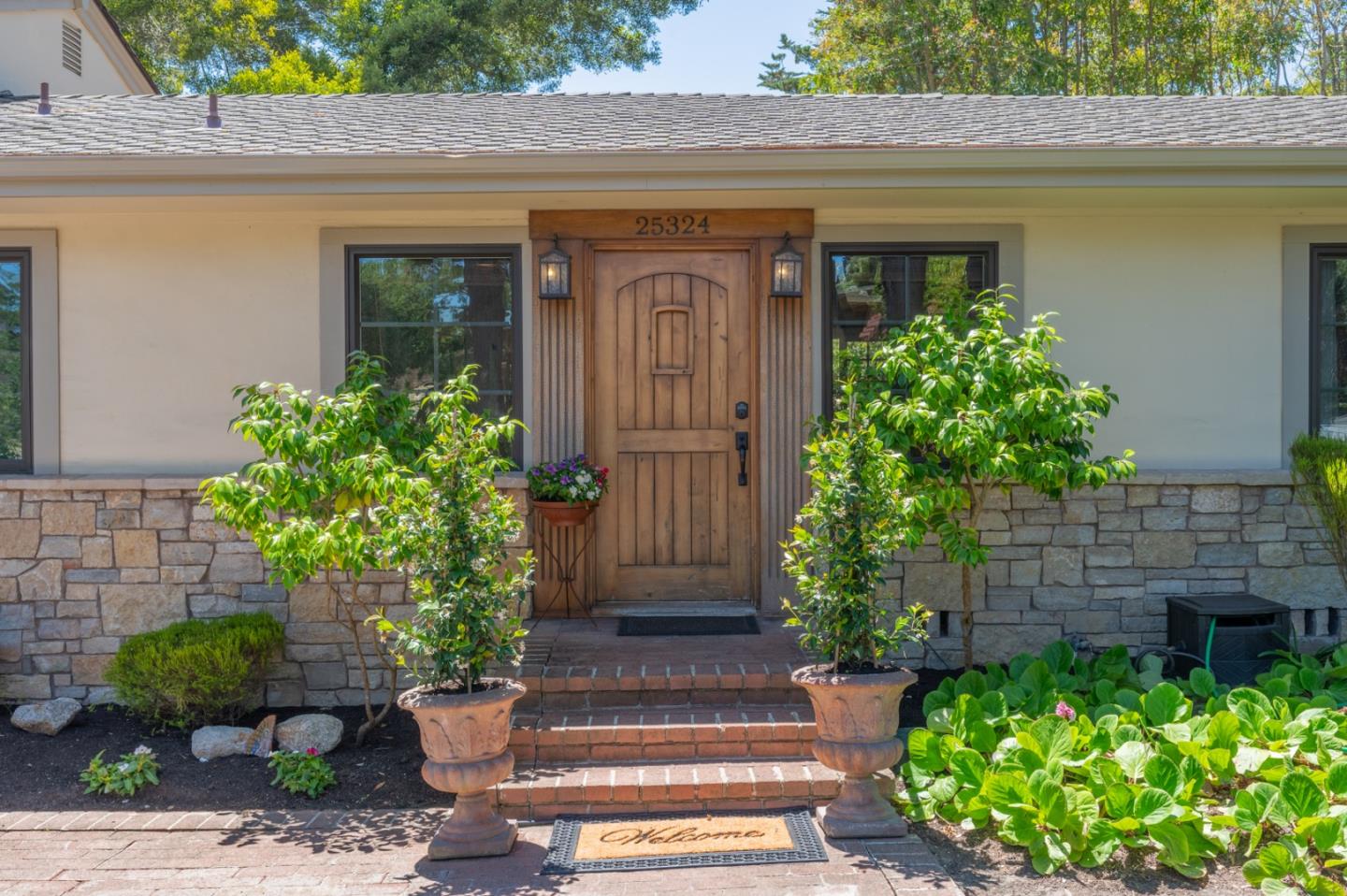 25324 Hatton Road Carmel, CA 93923 - Photo 2 of 19 a front view of a house with a yard
