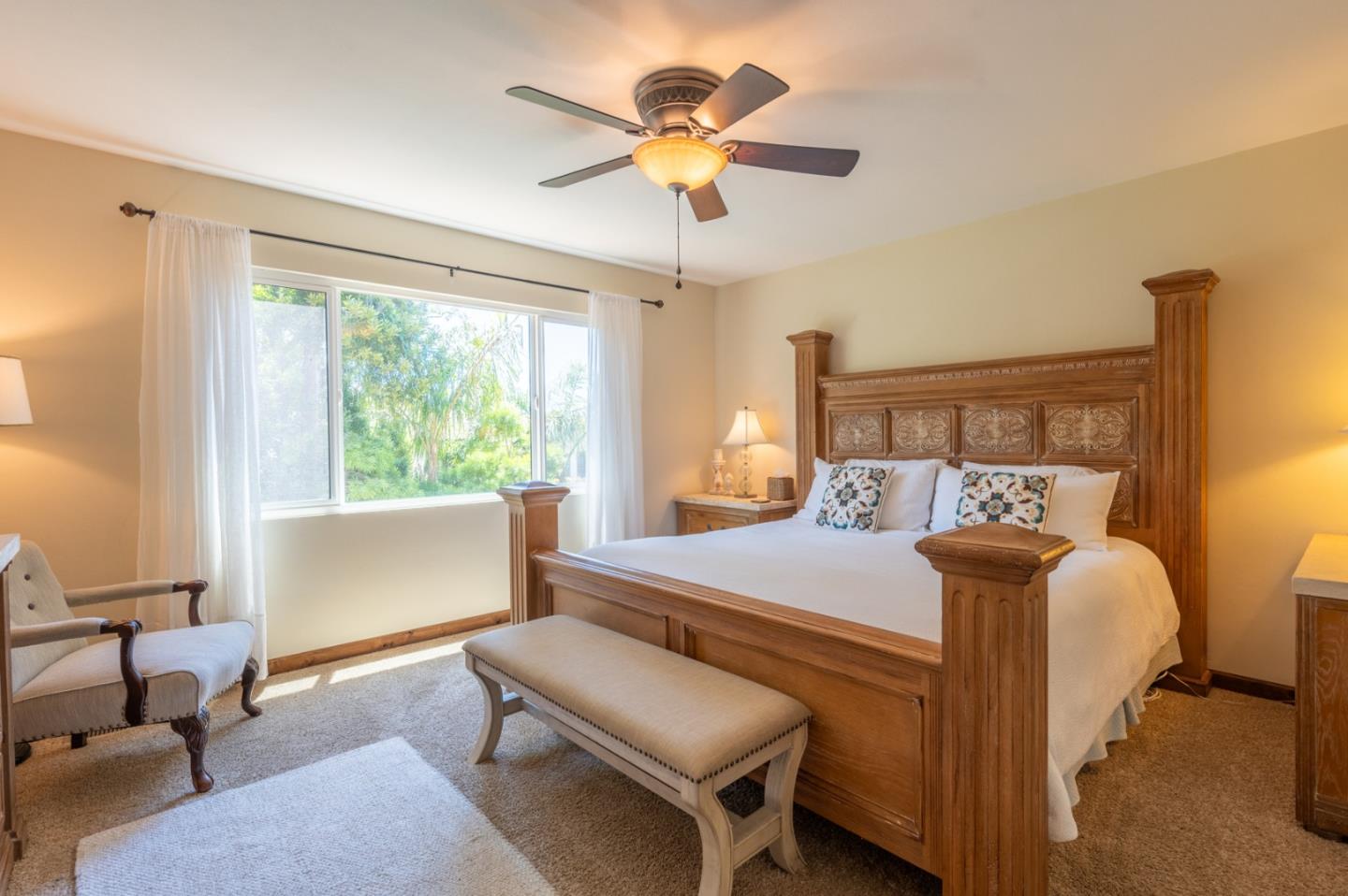 25324 Hatton Road Carmel, CA 93923 - Photo 10 of 19 a bedroom with a bed and a chandelier