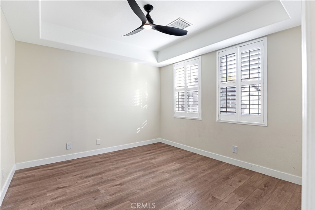 19 Garrison Loop Ladera Ranch, CA 92694 - Photo 13 of 21 a view of an empty room with wooden floor and a window