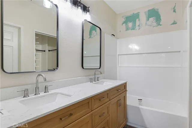 a bathroom with a double vanity sink and a mirror