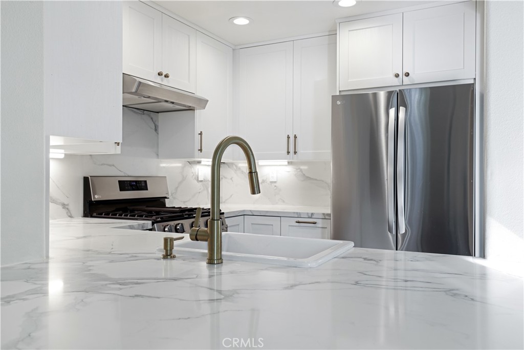 19 Garrison Loop Ladera Ranch, CA 92694 - Photo 3 of 21 a kitchen with stainless steel appliances kitchen island a refrigerator and a sink