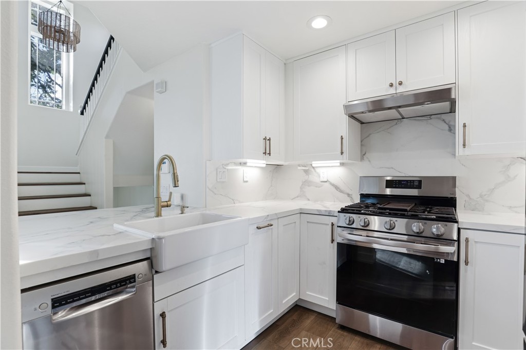 19 Garrison Loop Ladera Ranch, CA 92694 - Photo 5 of 21 a kitchen with white cabinets and appliances