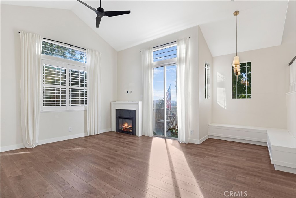19 Garrison Loop Ladera Ranch, CA 92694 - Photo 7 of 21 a view of empty room with wooden floor and fireplace