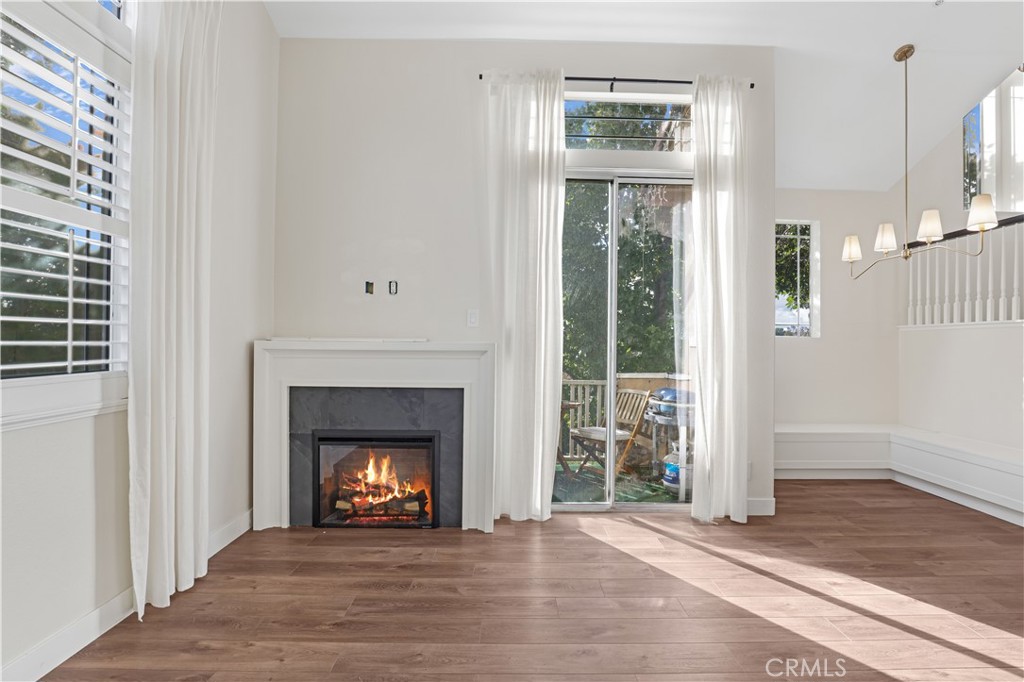 19 Garrison Loop Ladera Ranch, CA 92694 - Photo 9 of 21 a view of an empty room with wooden floor fireplace and a window