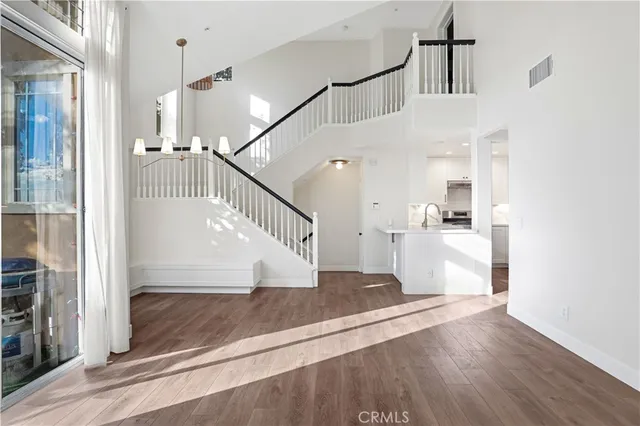 a view of entryway and hall with wooden floor