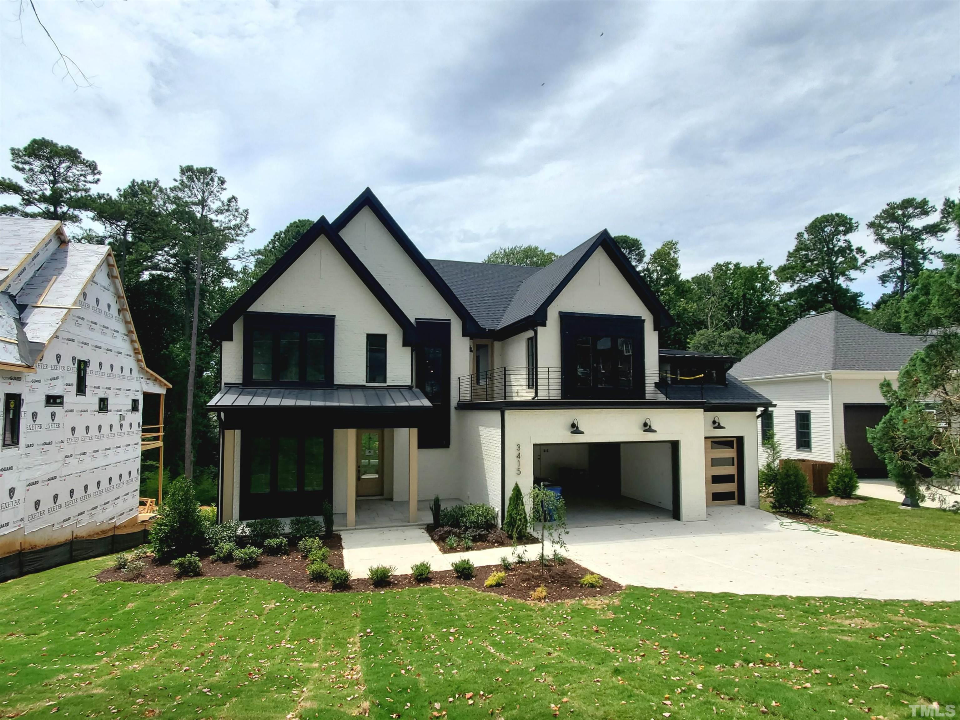 3415 Turnbridge Drive Raleigh, NC 27609 - Photo 1 of 9 a front view of a house with a yard and garage