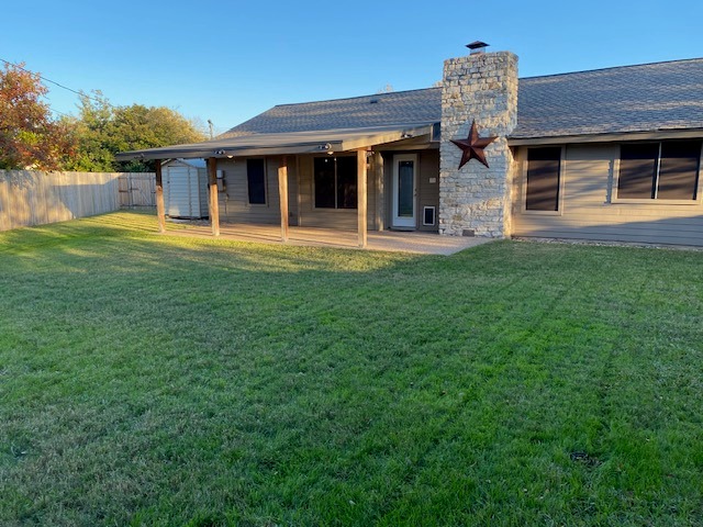 1002 Creekbend Cove Pflugerville, TX 78660 - Photo 3 of 16 Rear view of house featuring a chimney and roof with shingles