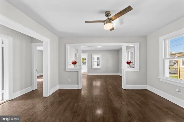 a kitchen with a sink appliances cabinets and a large window