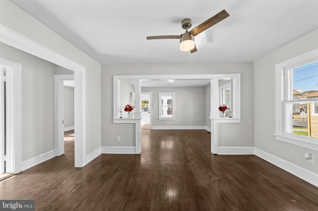 a kitchen with a sink appliances cabinets and a large window