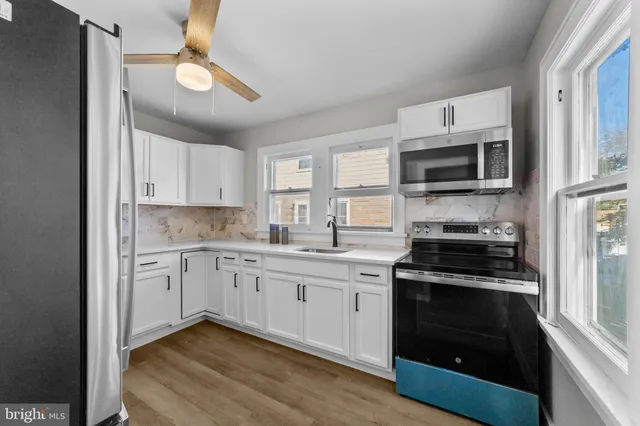 a kitchen with a sink a refrigerator and window
