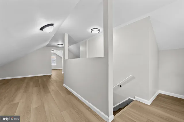 a view of a room with wooden floor