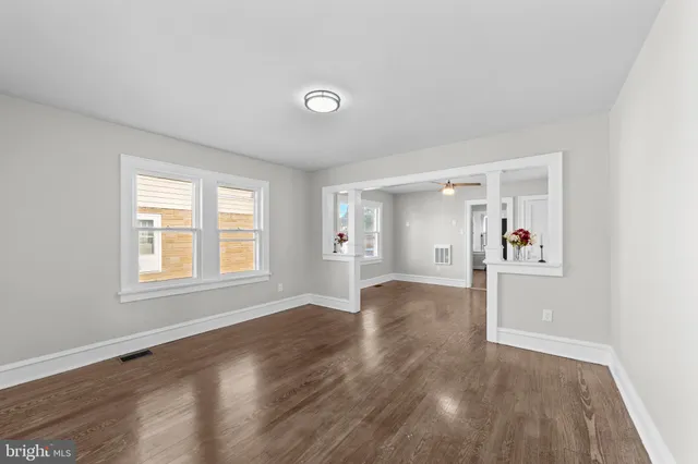 a view of a livingroom with a window and wooden floor