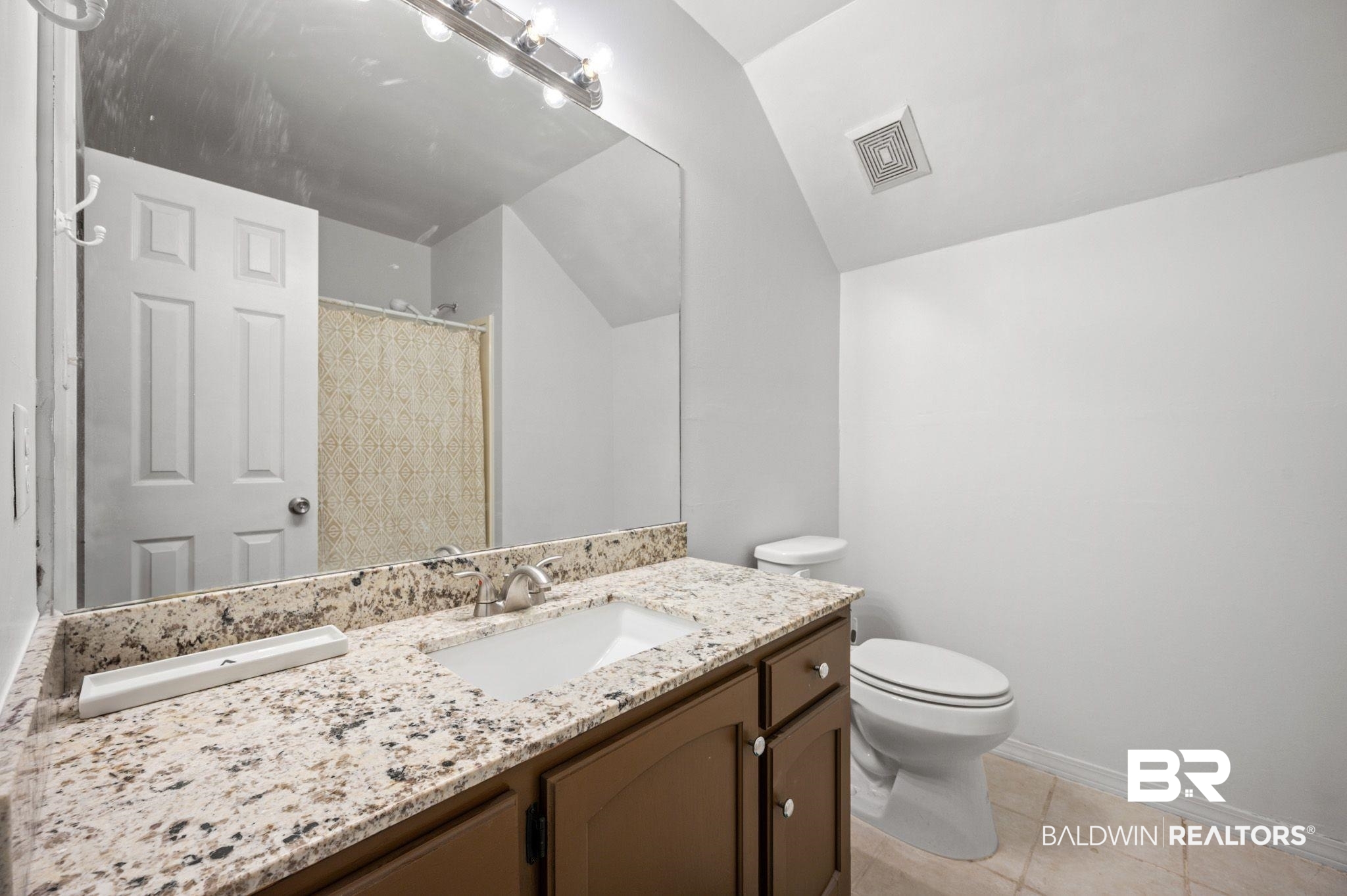 6705 Autumn Ridge Drive Mobile, AL 36695 - Photo 24 of 24 Bathroom with tile patterned floors, lofted ceiling, toilet, vanity, and a shower with shower curtain