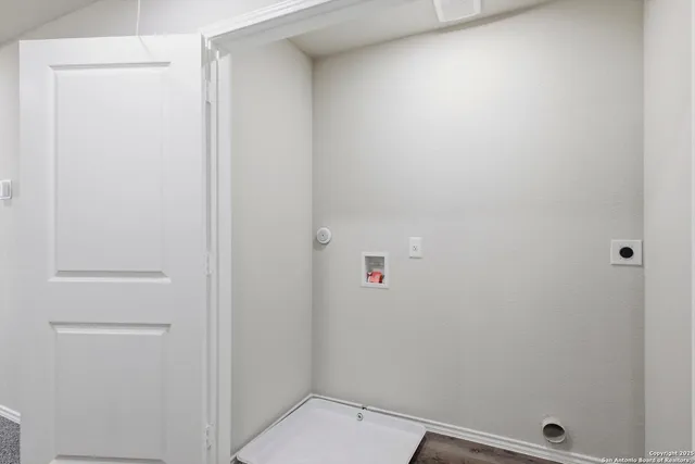 a view of a backyard with wooden fence