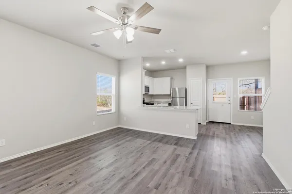 a view of a kitchen with a dishwasher cabinets and wooden floor