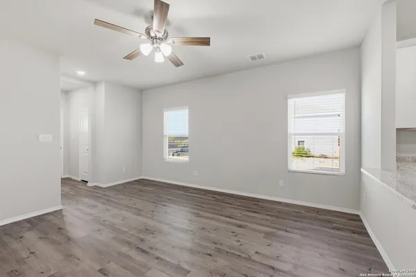 wooden floor in an empty room with a window