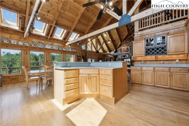 a kitchen with a sink a stove and chairs
