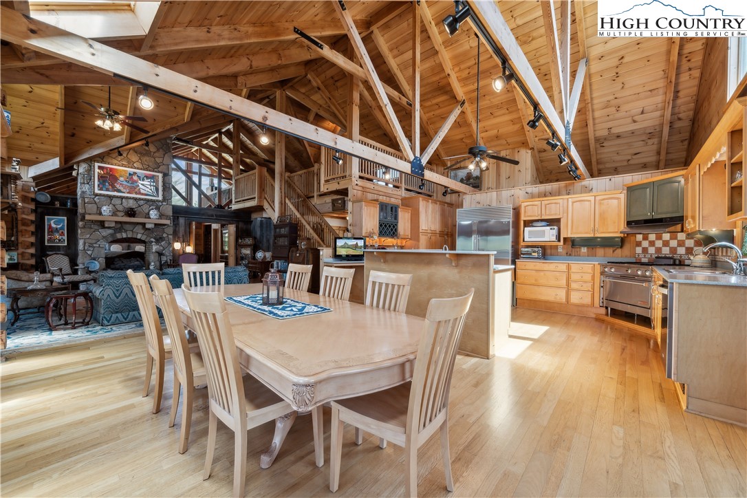 101 Double Branch Road Grassy Creek, NC 28631 - Photo 22 of 50 a dining room with stainless steel appliances kitchen island granite countertop a table chairs and a wooden floor