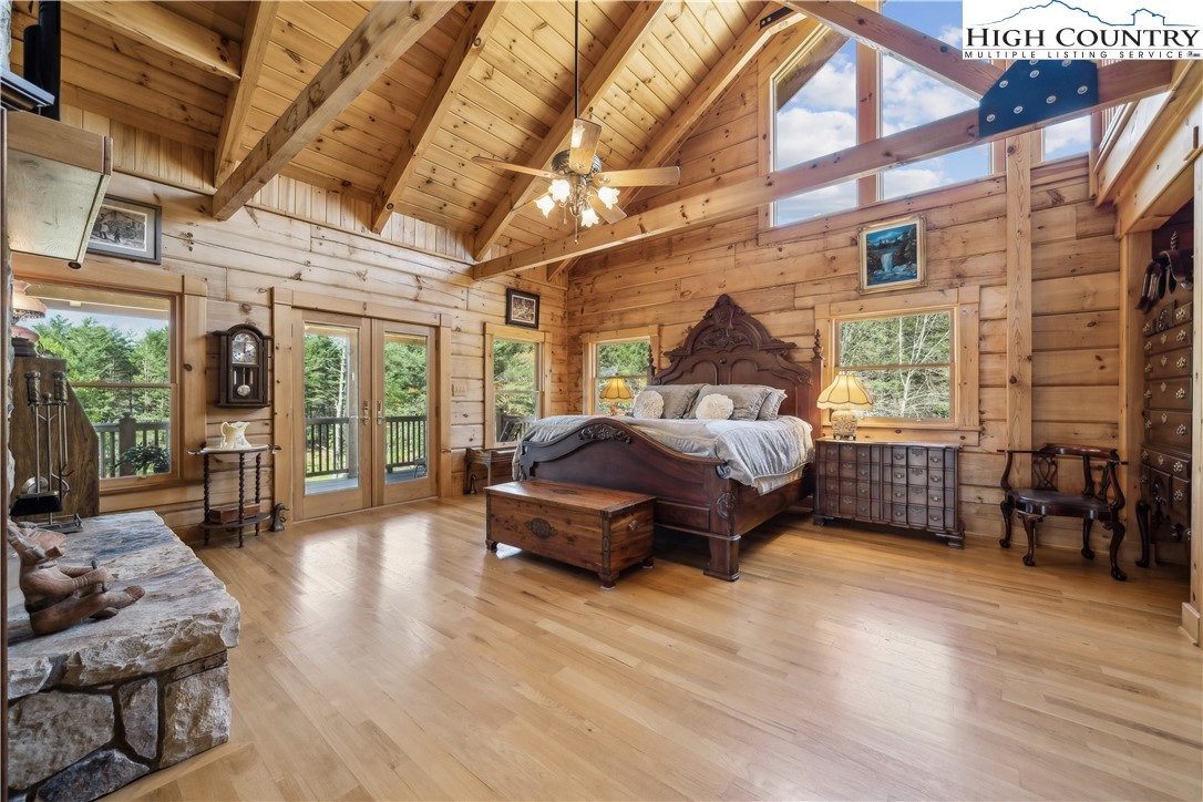 101 Double Branch Road Grassy Creek, NC 28631 - Photo 23 of 50 a spacious bedroom with a bed and wooden floor