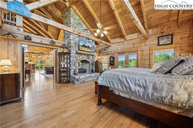 a bed sitting in a spacious bedroom next to a larger window