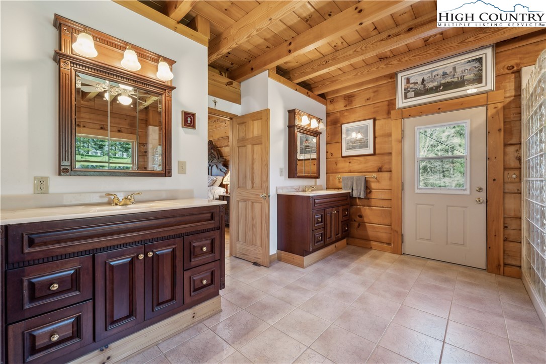 101 Double Branch Road Grassy Creek, NC 28631 - Photo 26 of 50 a spacious bathroom with a granite countertop sink and a bathtub