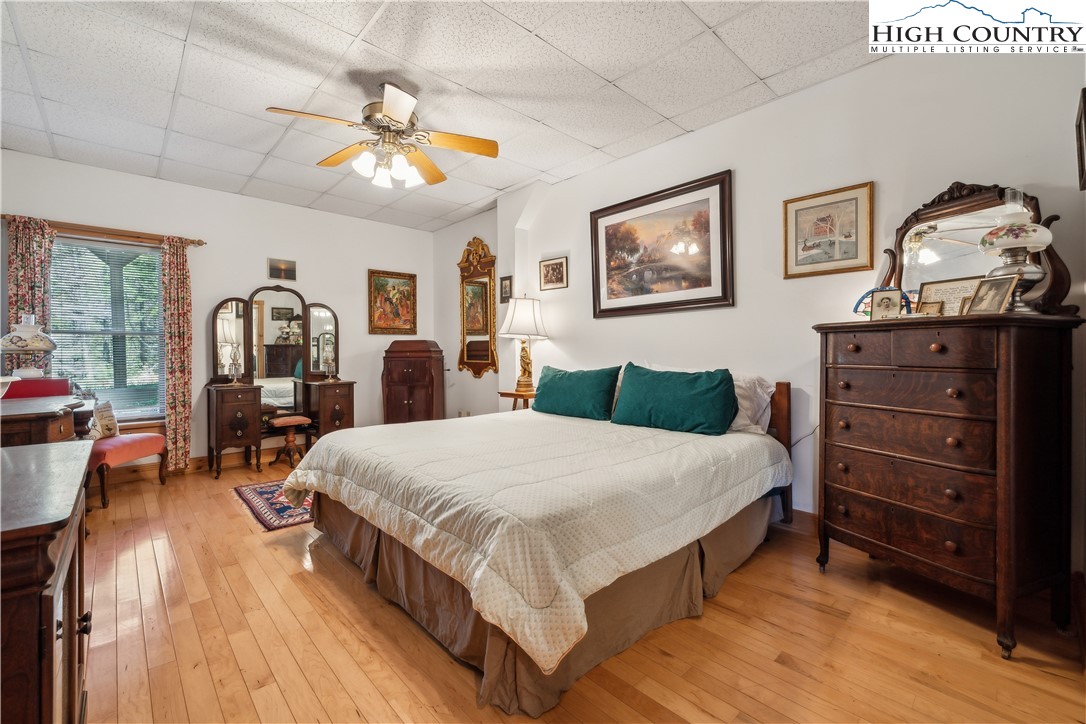 101 Double Branch Road Grassy Creek, NC 28631 - Photo 32 of 50 a spacious bedroom with a bed and wooden floor