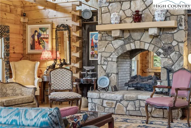 a spacious bedroom with a bed and wooden floor