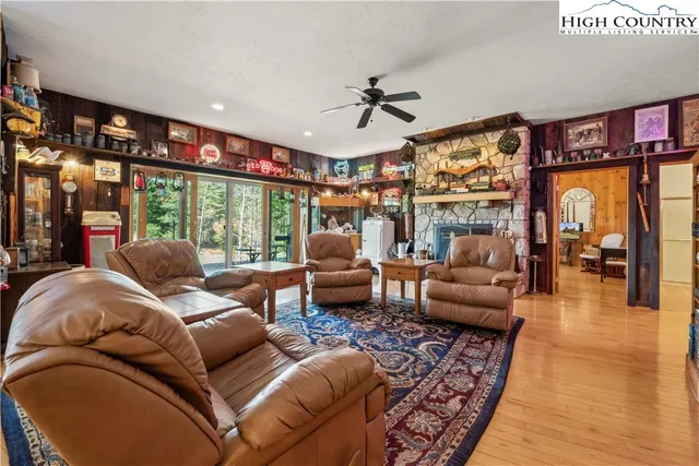 a living room with lots of furniture and a large window