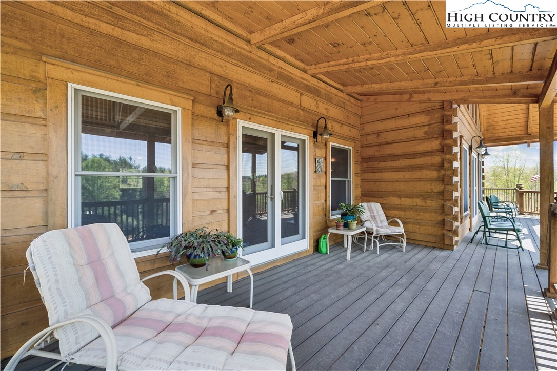 101 Double Branch Road Grassy Creek, NC 28631 - Photo 43 of 50 a balcony with chairs and wooden floor