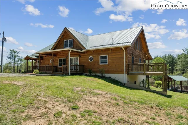 a backyard of a house with a yard table and chairs