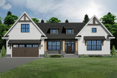 a front view of a house with a garden and yard