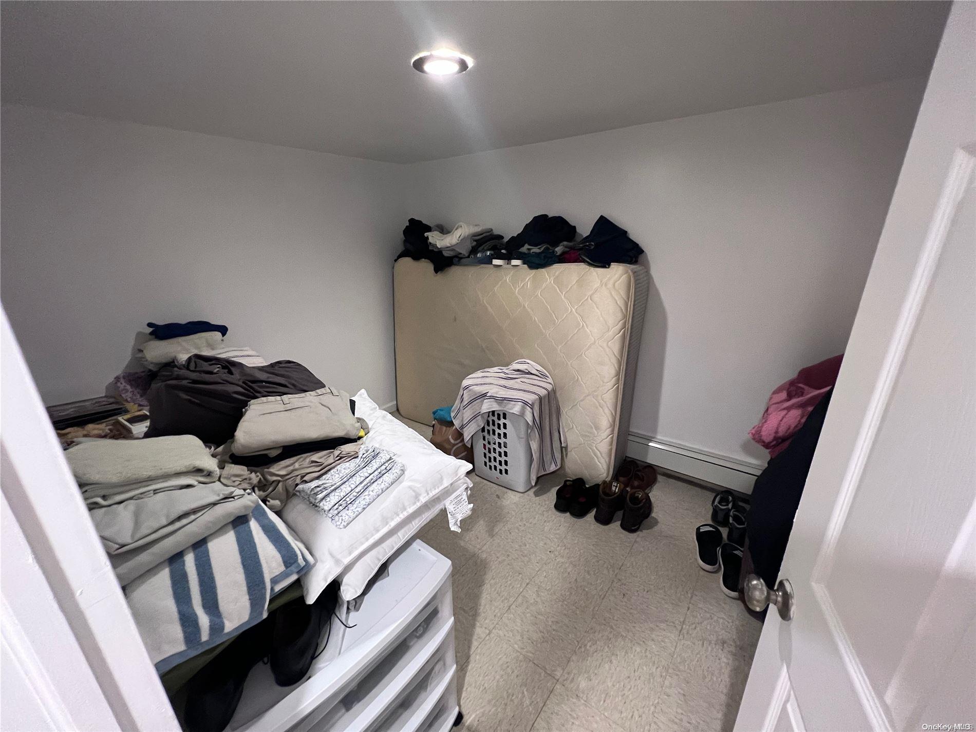 91-18 87th Street Queens, NY 11421 - Photo 16 of 22 a view of walk in closet with clothes and shoes