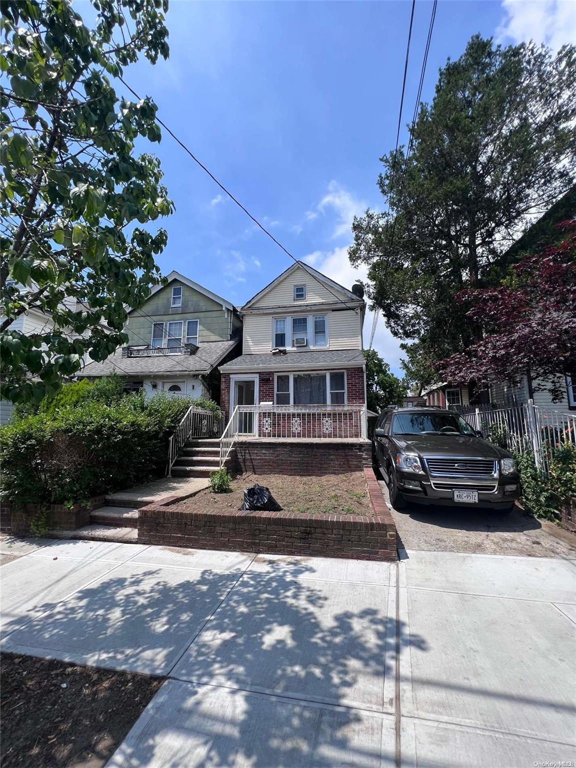 91-18 87th Street Queens, NY 11421 - Photo 22 of 22 a front view of a house with a yard