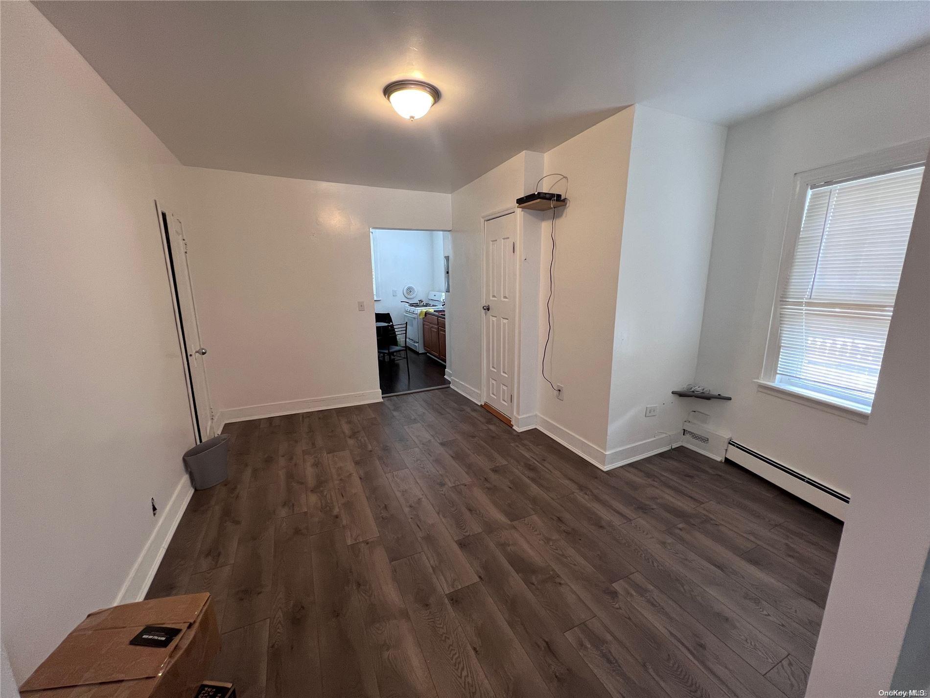 91-18 87th Street Queens, NY 11421 - Photo 3 of 22 a view of an empty room with a window