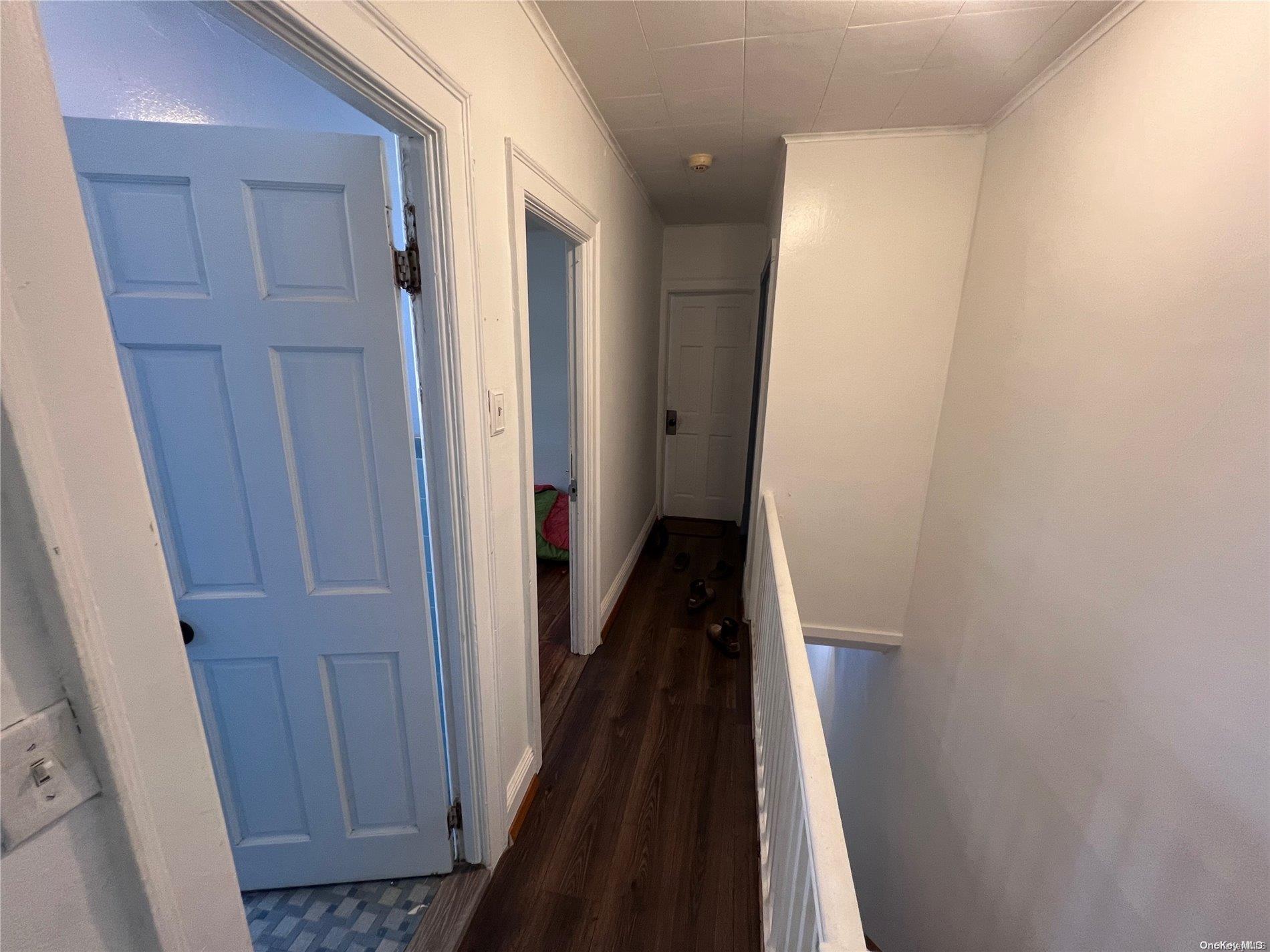 91-18 87th Street Queens, NY 11421 - Photo 9 of 22 a view of a hallway with wooden floor and staircase