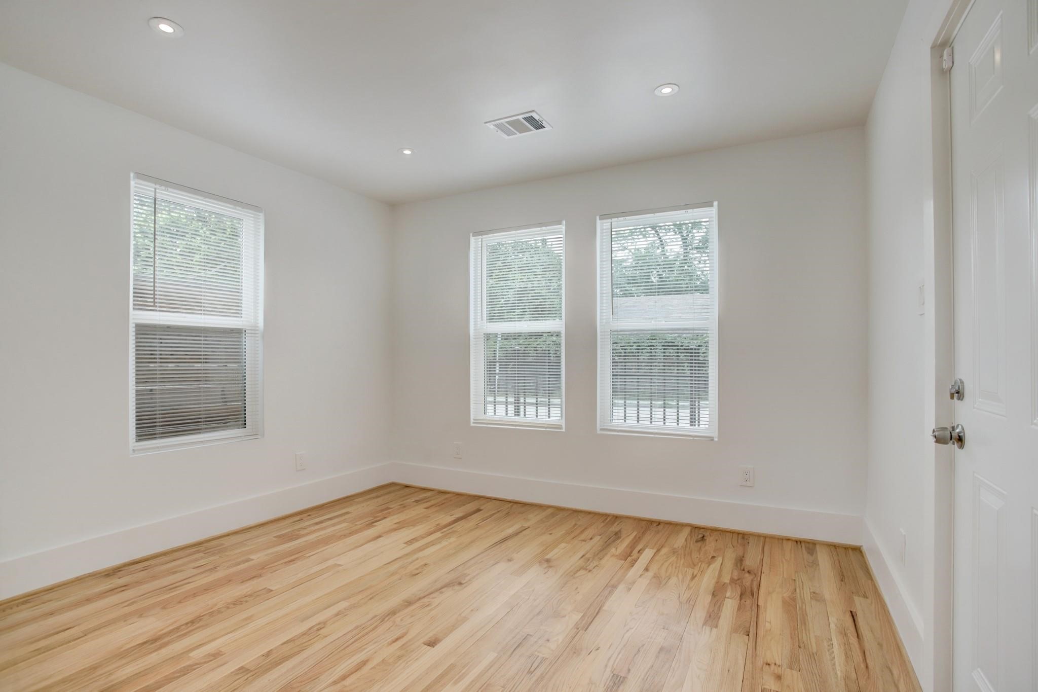 6109 North Main Street Houston, TX 77008 - Photo 11 of 16 a view of an empty room with wooden floor and a window