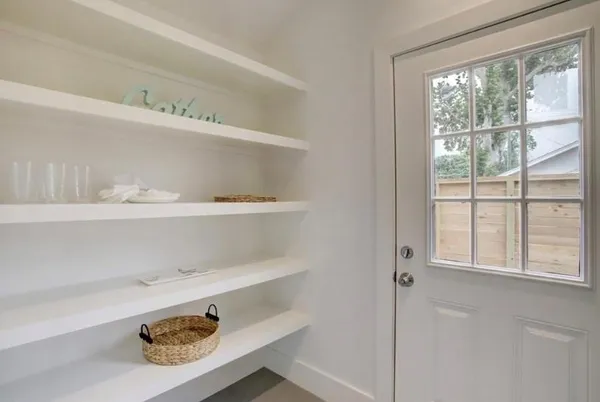 a shelf with a window and a lamp