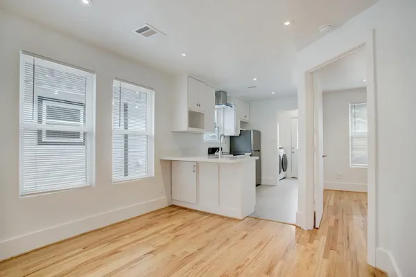 a view of kitchen with wooden floor and electronic appliances