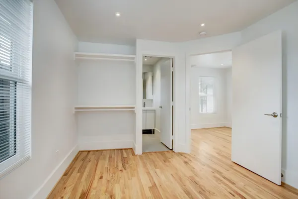 a view of empty room with wooden floor