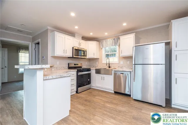 a kitchen with refrigerator cabinets and a sink