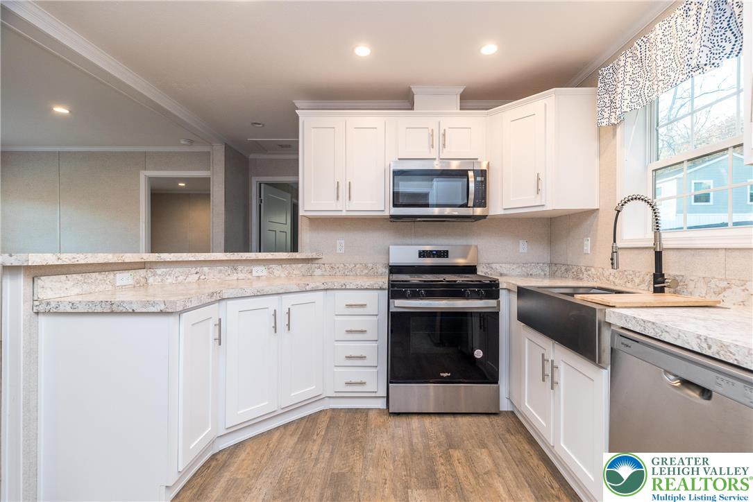 465 Royal Manor Road, Unit LOT 5 Easton, PA 18042 - Photo 3 of 24 a kitchen with stainless steel appliances a stove sink microwave and cabinets